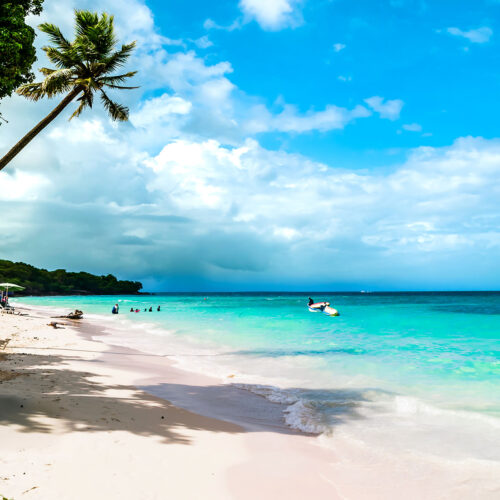 a white beach by turquoise sea in Colombia
